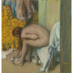 Nude woman wiping her left feet. A woman at her toilet