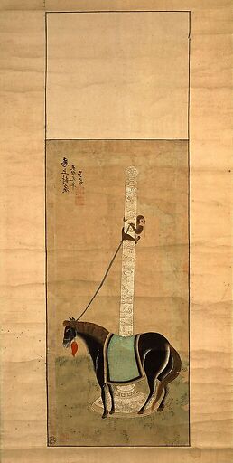 Cheval maintenu au poteau par un singe