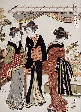 Women admiring peonies in bloom