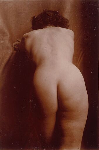 Naked woman standing up from behind, leaning, knee-high view