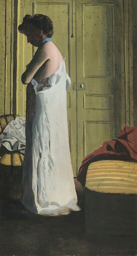 Nude in an interior, woman taking off her shirt
