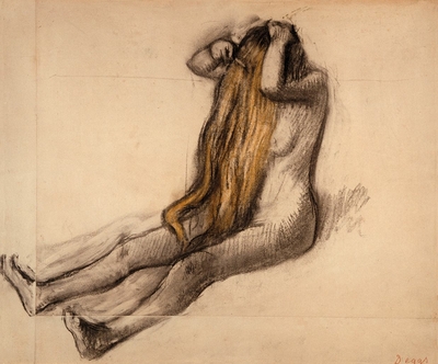 Woman sitting on the floor, combing her hair